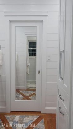 a white door and mirror in a room