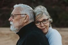 an older man and woman embracing each other