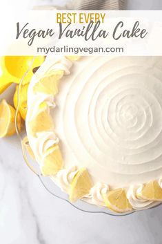 a lemon cake with cream cheese buttercream frosting and sliced lemons on the side