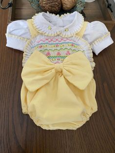 Pre-order handmade smocked romper. It takes 4-6 weeks to ship. Thank you for your patience. Thank you for supporting a small business. Clothing Care Instructions Most items can be washed safely in cold water on delicate cycle and hung to dry. If the item that you are ordering has red or another bright color in it next to a white or other light color fabric please use a Shout color catcher for the first few washes to avoid bleeding. The reds are pre-washed but they are still red and will likely h Spring Cotton Bubble Romper With Smocked Cuffs, Spring Bubble Romper With Smock Detail, Cute Cotton Bubble Romper With Smocked Bodice, White Bubble Romper With Smocked Back For Spring, Spring White Bubble Romper With Smocked Back, Spring Fitted Smocked Bubble Romper, Spring Fitted Smock Bubble Romper, Spring Bubble Romper With Smock For Playtime, Spring Smock Bubble Romper For Playtime