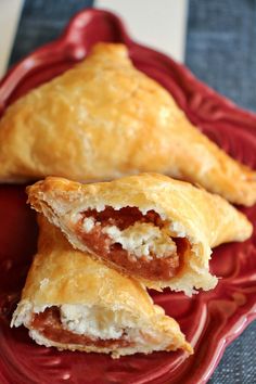 two pastries are on a red plate