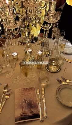 the table is set with wine glasses, silverware and napkins for an elegant dinner