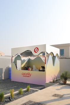 a building with a sign that says cococadilly on it's side and mountains in the background