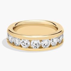 a yellow gold wedding ring with five stones on the side and two rows of diamonds