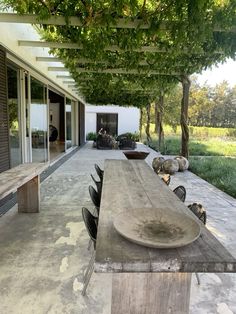 an outdoor dining area with wooden table and benches