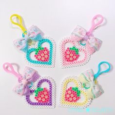 four crocheted hearts with bows on them