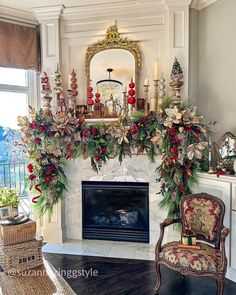 a fireplace decorated for christmas with greenery and candles