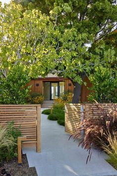 an outdoor garden with wooden benches and trees