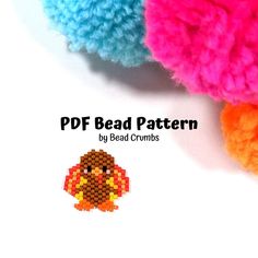 three crocheted pom poms are shown in different colors