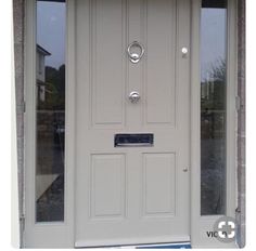 a white front door with two sidelights