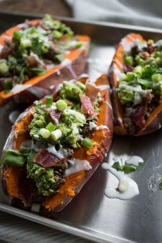 baked sweet potatoes topped with broccoli and other toppings on a baking sheet