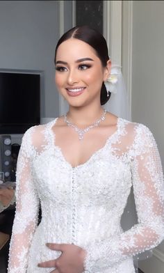 a woman in a wedding dress posing for the camera