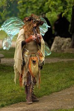 a woman dressed as a fairy holding an umbrella