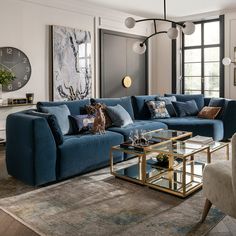 a living room filled with furniture and a large clock mounted to the wall above it