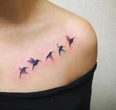 a woman's shoulder with three birds on it