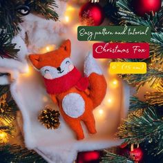 an orange stuffed animal sitting on top of a christmas tree