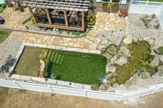 an aerial view of a house with a pond in the yard