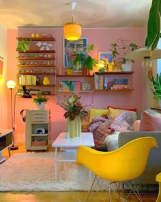 a living room filled with furniture and lots of bookshelves on top of shelves