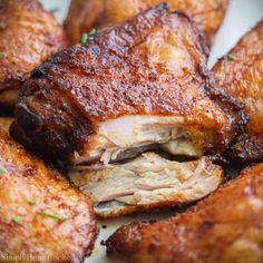 closeup of chicken wings with herbs on the side