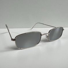 Vintage Y2K 90s 2000s unique slim style silver trim mirror lens sunglasses Silver Sunglasses For Summer Streetwear, Trendy Silver Rectangular Sunglasses, Silver Rectangular Sunglasses With Mirrored Lenses, Blue Ray Bans, Vuarnet Sunglasses, Alexander Mcqueen Sunglasses, Sunglasses Men Vintage, Costa Sunglasses, Oliver Peoples Sunglasses