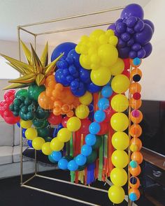 a bunch of balloons that are on a stand