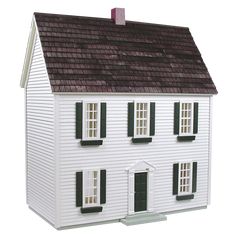 a white doll house with black shutters and windows