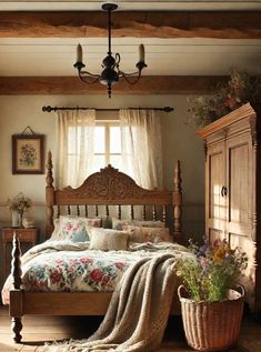 a bed sitting under a window next to a wooden dresser