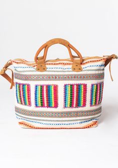 Travel in style with this ultra-bohemian weekender travel bag. A colorful statement piece featuring embroidered details, a zip-top closure, and suede trim. The large carry-all size is perfect for last-minute getaways. Embroidered Stitch details Zip-top closure Suede leather top handles Leather shoulder strap Bohemian weekender bag Dimensions: 24" X 17 3/4"Style: DR-8474 Bohemian Multicolor Weekender Bag For Everyday Use, Bohemian Weekender Bag With Leather Handles, Bohemian Multicolor Travel Bag, Bohemian Multicolor Shoulder Weekender Bag, Travel-ready Multicolor Embroidered Hobo Shoulder Bag, Boho Travel, Weekend Travel Bags, Bohemian Colors