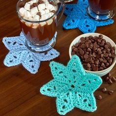 hot chocolate and marshmallows in crochet star coasters on a table