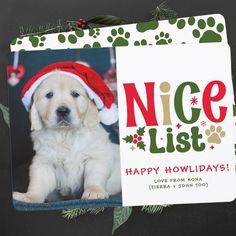 a dog with a santa hat is sitting in front of a card that says nice list happy holidays