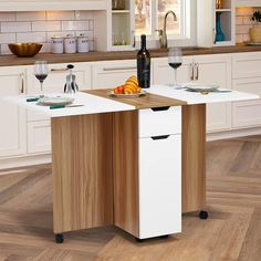 a kitchen island with two wine glasses on it