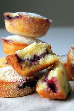 a pile of blueberry muffins sitting on top of a table next to each other