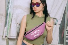 a woman wearing sunglasses and a pink fanny bag with the words flower girl on it