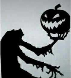 a black and white image of a person holding a pumpkin