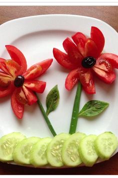 a white plate topped with cucumber slices and flowers