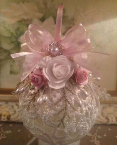 a white vase with pink flowers in it