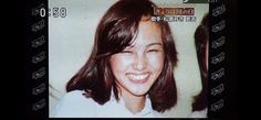 an old photo of a woman smiling and looking at the camera with words on it