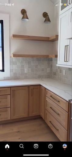 a kitchen with wooden cabinets and white counter tops