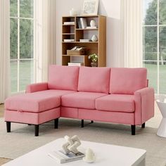 a living room with a pink sectional couch