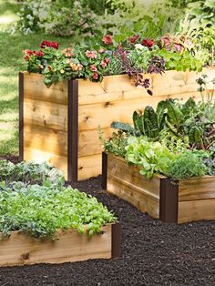 several wooden planters filled with different types of plants and flowers in the garden, text reads made in vermont lifetime raised bed corners