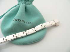 Feel like making a statement with your jewelry? Here's one that fits the bill wonderfully. Offered for sale is a gorgeous and super awesome Tiffany and Co. Silver Rectangle Link ID bracelet. A truly unique and awesome bracelet - you will be one of the few to own this piece (I am 100% sure of it!). It is the perfect piece to wear when you want to make a classy and elegant statement. Wonderful and very contemporary bracelet that fits a lifestyle on the go -- this piece can be worn to almost any oc Elegant Bracelet Tiffany & Co., Contemporary Bracelets, Id Bracelets, Tiffany And Co, Tiffany & Co., Link Bracelets, Bangle Bracelets, Knitted Hats, Bangles