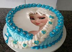 a frozen princess cake on a wooden table