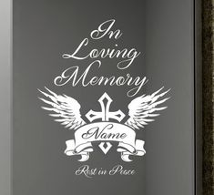 an image of a memorial plaque with wings and cross on it, in loving memory