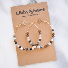 Six ultra-luxe neutral gemstones cover these large gold-filled hoops for a cool wear-with-everything style. Who wouldn't love earrings that take the guesswork out of accessorizing? 45mm (about 1.75") gold-filled hoops with real gemstone beads includes tiger eye, moonstone, black spinel, pink opal, pyrite and labradorite ready for gift giving, packaged on a kraft earring card in a clear resealing sleeve includes earring back for security limited quantities Earrings Diy Ideas, Love Earrings, Earring Card, Gold Filled Hoops, Loop Earrings, Earring Cards, Black Spinel, Beaded Hoop Earrings, Beaded Hoops