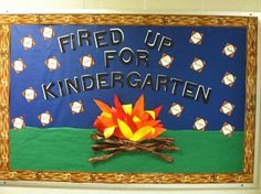 a bulletin board with fire up for kindergartn written on it and an image of a campfire