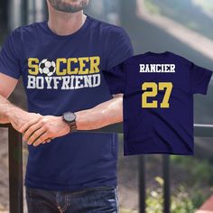 a man wearing a soccer boyfriend t - shirt with the number 27 printed on it