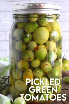 pickled green tomatoes in a glass jar with the words pickled green tomatoes inside