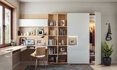 a living room filled with lots of furniture and bookshelves next to a window