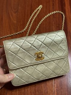 This vintage Chanel mini wallet on chain bag is perfect for any woman who wants to carry her essentials in style. The gold exterior color and lamb skin leather material give it a sophisticated look, while the Flag theme adds a touch of uniqueness. With its 3 in 1 design, it can be used as a wallet, clutch, shoulder bag, crossbody bag and a waist bag. The Brand name speaks for itself and it's the perfect accessory for any occasion. Vintage condition with wear on gold, especially on the back, front has some creased mark, chain has wear on gold. Back also has some dirt mark ( shown in the last picture) Chain can be taken off for clutch, or double chain for shoulder bag. I actually use it as waist bag! 3 in 1 bag! It comes with card but bag doesn’t has serial number on it, possibly felt off be Classic Gold Wallet On Chain For Formal Events, Classic Gold Wallet On Chain For Formal Occasion, Classic Gold Wallet On Chain, Chic Compact Gold Bag, Classic Gold Wallet On Chain For Travel, Classic Gold Wallet On Chain With Gold-tone Hardware, Gold Clutch Wallet On Chain With Gold-tone Hardware, Luxury Gold Wallet On Chain Clutch, Gold Rectangular Wallet On Chain For Everyday Use