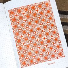 an open notebook with orange designs on it